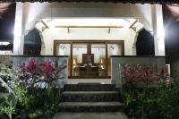 a building with a glass door and some plants at Rinjani Lodge in Senaru