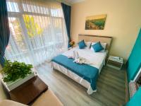 a bedroom with a bed and a large window at CityHub in Antalya
