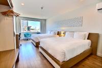 リムースキにあるHôtel Le Navigateurのベッドが2つあり、大きな窓があるホテルの部屋