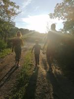 two adults and a child walking down a dirt road at L&#39;auberge 10 à 15 pers 30min zoo beauval chambord cheverny in Langon