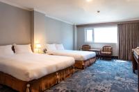 a hotel room with two beds and a window at Chiayi King Hotel in Chiayi City