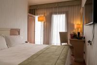 Łóżko lub łóżka w pokoju w obiekcie Hotel Roxy Plaza