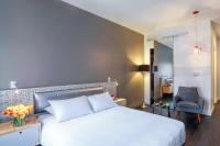 a bedroom with a white bed and a chair at NU Hotel in Brooklyn