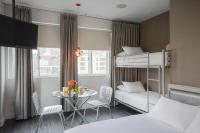 a small room with two bunk beds and a table at NU Hotel in Brooklyn