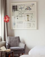 a living room with a chair and a drawing on the wall at NU Hotel in Brooklyn