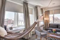 a hammock in a living room with windows at NU Hotel in Brooklyn