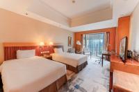 a hotel room with two beds and a television at Park Plaza Beijing Wangfujing in Beijing