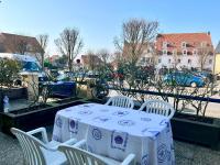 a table with white chairs and a blue and white table cloth at COC - La Belle Etoile in Wissant