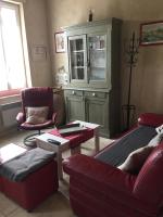 a living room with a couch and a cabinet at Maison au bord de mer in Saintes-Maries-de-la-Mer