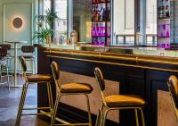 a bar with three chairs and a counter at Axel Hotel Barcelona - Adults Only in Barcelona