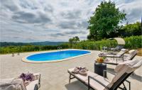 a patio with chairs and a swimming pool at 3 Bedroom Nice Home In Rukljevina in Gornja Poljana