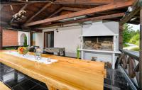 a large wooden table in a kitchen with a stove at 3 Bedroom Nice Home In Rukljevina in Gornja Poljana