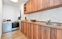 a kitchen with wooden cabinets and a sink at 3 Bedroom Nice Home In Rukljevina in Gornja Poljana