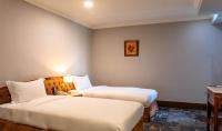 a hotel room with two beds and a table at Chiayi King Hotel in Chiayi City