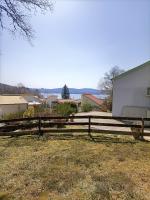 a wooden fence in front of a house at Au bord du lac in Royère-de-Vassivière