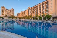 a pool at the resort with chairs and buildings at Lake River Side Hotel Spa in Side