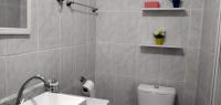 a bathroom with a white toilet and a sink at Casa com Piscina Paraty in Paraty