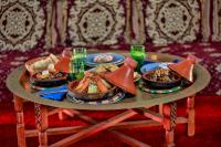 a table with several plates of food on it at Riad Catalina in Marrakech
