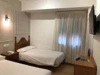 Posteľ alebo postele v izbe v ubytovaní Hostal La Mexicana