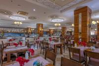a restaurant with tables and chairs with red bows at Lake River Side Hotel Spa in Side