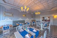 a restaurant with blue and white tables and chairs at Lake River Side Hotel Spa in Side