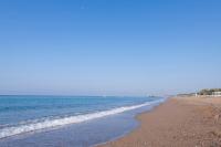 a beach with waves coming in from the ocean at Lake River Side Hotel Spa in Side