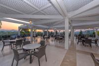 a restaurant with tables and chairs with a view at Lake River Side Hotel Spa in Side