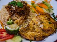 a plate of food with noodles and meat and vegetables at HOTEL CENTRAL PARK & CONFERENCE CENTRE in Nairobi