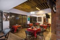a restaurant with red tables and chairs in a room at HOTEL CENTRAL PARK & CONFERENCE CENTRE in Nairobi