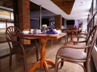 a row of tables and chairs in a restaurant at HOTEL CENTRAL PARK & CONFERENCE CENTRE in Nairobi
