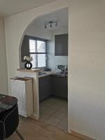a kitchen with an archway leading into a kitchen with a sink at Grand studio de 33m² à 300m des plages in Vallauris