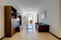 a living room with a couch and a table at Modern 2 Bedroom Maisonette in Central Sliema in Sliema