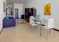 a living room with a dining room table and chairs at Modern 2 Bedroom Maisonette in Central Sliema in Sliema