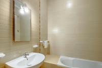 a bathroom with a sink and a mirror and a tub at Modern 2 Bedroom Maisonette in Central Sliema in Sliema