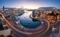 a city at night with a river and buildings at Modern 2 Bedroom Maisonette in Central Sliema in Sliema