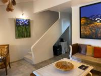 a living room with a couch and a staircase at Mas de la Beaume in Gordes