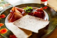 a plate of food with slices of bread and watermelon at Hakkesetstølen Fjellstugu in Geilo