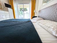 Een bed of bedden in een kamer bij L&#39;appartement Royal Palm