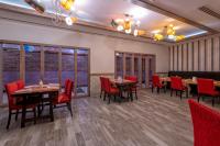 a dining room with tables and chairs and windows at Lake River Side Hotel Spa in Side
