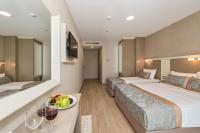 A bed or beds in a room at Marcello Hotel