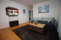 Televízia a/alebo spoločenská miestnosť v ubytovaní Moderan apartman u blizini mora