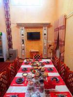 a long table with a red and white table cloth at Shodlik Guest House in Khiva