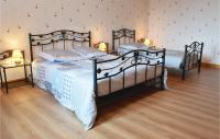 two twin beds in a room with two lamps at Nice Home In Canchy With Kitchen in Canchy