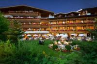 a hotel with a garden in front of it at Salzburgerhof, das 5-Sterne Hotel von Zell am See in Zell am See