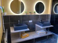 a bathroom with two sinks and two mirrors at Nouveau !! Bel appartement à Fécamp tout près de la plage, gare et voie verte in Fécamp