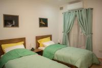 two beds sitting next to each other in a bedroom at Spacious 3 bedroom apartment in Marsascala in Marsaskala
