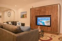 a living room with a couch and a flat screen tv at Spacious 3 bedroom apartment in Marsascala in Marsaskala