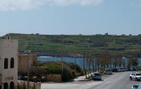 a street with cars parked on the side of a road at Spacious 3 bedroom apartment in Marsascala in Marsaskala