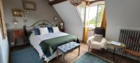 a bedroom with a bed and a chair and a window at Moulin de Giboudet Chambres d&#39;hôtes in Bazainville