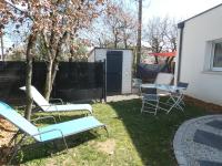a yard with chairs and a table and a fence at Grain de Sable et son Jacuzzi in Talmont